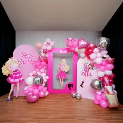 A Barbie dream party with all the pink and sparkle you can imagine. This setup features multiple backdrops, a life-sized photo frame, character cutouts, and fabulous balloon arrangements with disco ball accents.
