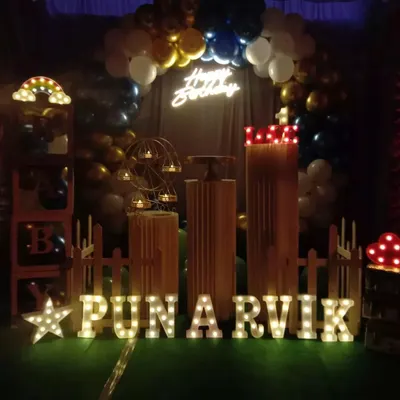 This setup shows how props can create a complete theme. I used marquee letters for the name "PUNARVIK", a light-up star, a picket fence, and "BABY" display boxes to build a charming scene for a first birthday.