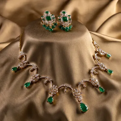 The complete Aurora Verde bridal set. We paired natural Zambian emeralds with a mix of round and baguette diamonds in 18K gold to create a look that feels both classic and modern. The necklace and matching earrings are designed for presence and balance.