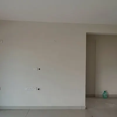 Before: An empty living room wall in 'The Flux Abode'. This is the blank canvas I start with.