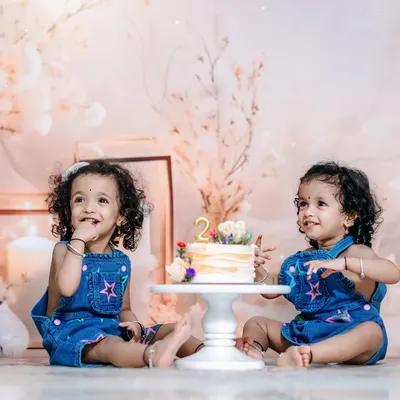Double the sweetness! Twin girls celebrating their second birthday with a cake in our dreamy, light-filled studio. Capturing the bond between twins is truly special.