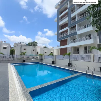 A view of the swimming pool I designed as part of a luxury apartment complex. The two-tiered pool is perfect for both laps and leisure, surrounded by a clean, modern deck and the residential tower in the background.