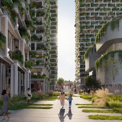 The central pedestrian spine of the Sky Gardens project in Hyderabad, flanked by towers with lush green facades. This space is designed as a vibrant community hub, promoting walkability and social interaction.