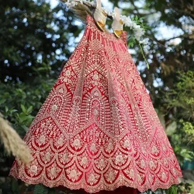 Get your dream wedding lehenga, whether you want it custom-stitched or on rent. This stunning red velvet piece is a classic choice for any bride.