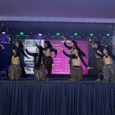 A large group of women performing a synchronized piece for the Kannada Rajyotsava community celebration. Coordinating big groups to move as one is a challenge I absolutely love.