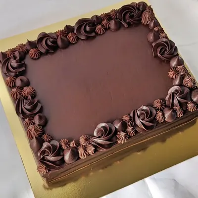 Sheet cakes are the perfect solution for serving a crowd. This is a classic dark chocolate sheet cake with a beautifully piped border, ready to be customized with a message or served as is for a simple, delicious treat.