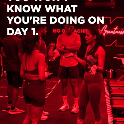 You won't know what you're doing on day one, and that is perfectly okay. Here, a coach explains the workout to a small group, ensuring everyone feels clear and supported before they begin.