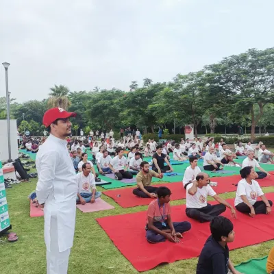 Addressing a large gathering during an outdoor yoga event. It is my passion to share the benefits of yoga with as many people as possible, creating a wave of positive energy.