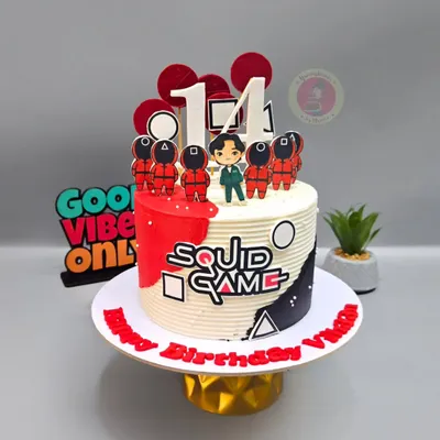 A "Squid Game" themed cake for a 14th birthday, featuring the iconic characters and symbols from the show.
