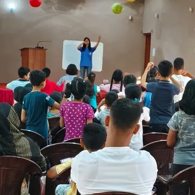 A view from the back of our parent counseling and demo session in Ranchi. You can see children actively participating on stage while parents observe. We believe in involving the entire family in the learning process.