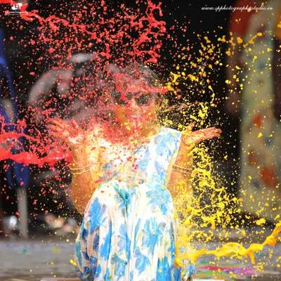 Capturing the explosion of color and fun during a Haldi ceremony. This high-energy shot freezes the moment perfectly, showcasing the joy and playful spirit of the event.