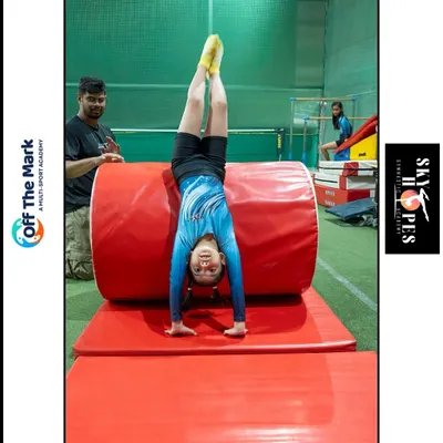 Control is a flex. A young gymnast demonstrates a perfect handstand using our training equipment, showing incredible strength and balance.
