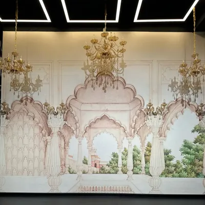 A close-up of our hand-painted Haveli-style set. The detailed murals, arches, and golden chandeliers are designed to give your shoots a touch of royalty, perfect for wedding choreography, classical dance, or ethnic fashion campaigns.