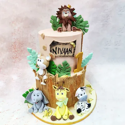Our two-tier Bamboo Safari Cake is a jungle celebration, featuring a crowned lion, monkey, elephant, giraffe, and zebra in a lush, wood-textured setting.