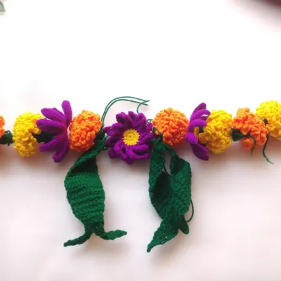 A new project in progress. I am combining classic orange marigolds with purple flowers to create a unique and colorful floral toran.