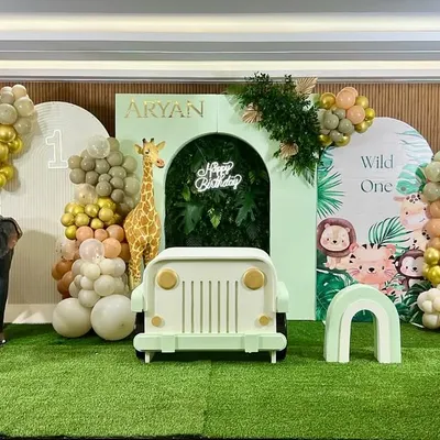 Get ready for a jungle adventure with Aryan's 'Wild One' first birthday party. We created a full safari scene with a jeep prop, life-sized giraffe and zebra figures, and lush greenery, all set against a custom backdrop with cute jungle animals.