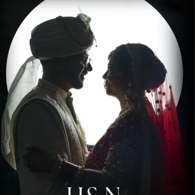 A dramatic silhouette of the bride and groom against a full moon, a creative and timeless wedding portrait.