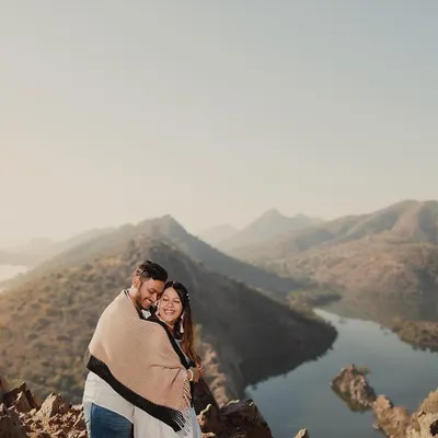 There's nothing like the quiet of the mountains at sunrise. Wrapped in a blanket against the morning chill, this couple shared a beautiful moment overlooking the serene lakes of Rajasthan.