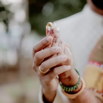 The moment forever begins. This close-up on the ring exchange is tightly framed to capture the intimacy and significance of the promise being made.