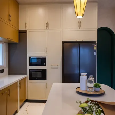 The open kitchen in the 'Sukoon' project, showing the built-in microwave and oven tower and the seamless integration with the living space.