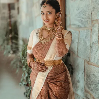 A portrait of timeless South Indian bridal beauty. I focus on capturing the intricate details of the silk saree, the temple jewelry, and the bride's serene expression.