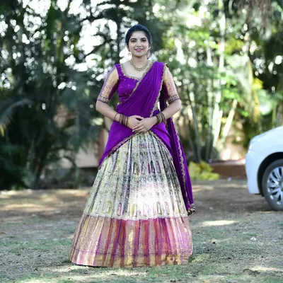 Dr. Nikitha looks absolutely radiant in this custom langa voni, created from a beautiful silk saree. The rich purple and intricate gold border were preserved to create this timeless piece.