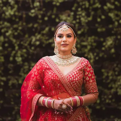 For this bride, the focus was on creating a regal and radiant look. I used a combination of soft contouring and a luminous foundation to give her a sculpted yet natural finish that perfectly complements her red lehenga.