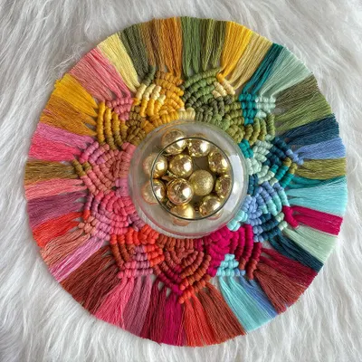 My macrame rangoli is a sustainable way to decorate for Diwali. This piece is full of vibrant colors and can be used as a table centerpiece with a diya or hung on the wall after the festival.