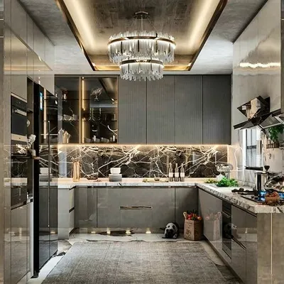 A modern luxury kitchen that balances sleek grey cabinetry and a marble backsplash with a statement crystal chandelier. We love designs that mix functionality with glamour, using elements like coffered ceilings and integrated lighting to elevate the space.
