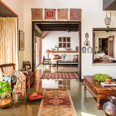 This view through the home shows how I create interconnected spaces that flow into one another. Polished stone floors reflect the light, while traditional dhurries and antique furniture root the modern design in a sense of place and history.