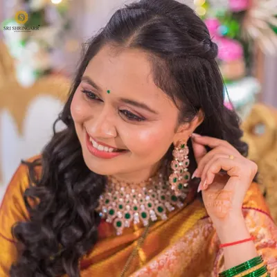 A happy client looking beautiful in our American diamond and green bead necklace set. Her smile is our best testimonial.