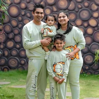 A perfect family day out. We love it when families coordinate their outfits, like these adorable matching sweatshirts. This outdoor portrait captures the happy, united spirit of this family of four.