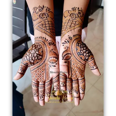 A beautiful floral mehendi design with a modern twist. This pattern combines rose motifs with geometric grids and bold peacock-inspired shapes for a unique and stylish look.
