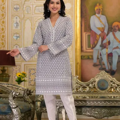 This grey printed V-neck kurta is paired with stylish white tulip pants. It's a complete outfit that is perfect for work, casual outings, or small family functions, offering a blend of comfort and modern design.