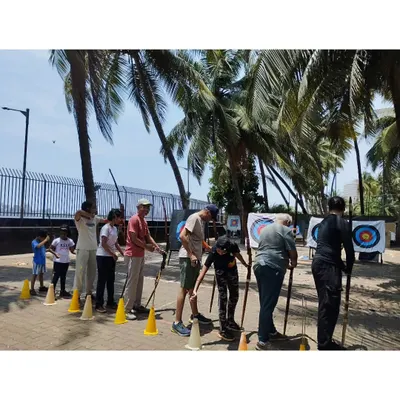 Our outdoor range in Dadar offers a beautiful setting with palm trees and open space, perfect for daytime archery practice.