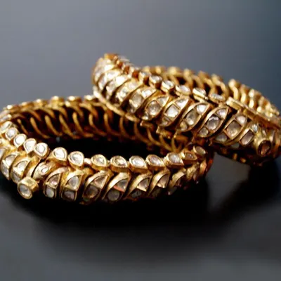A pair of traditional 'Shrankhla Jodi' twisted bangles from Gwalior, circa 1820. These flexible bangles are crafted in 22-carat gold and set with diamond polkis, representing a rare piece of Maratha royal heritage.