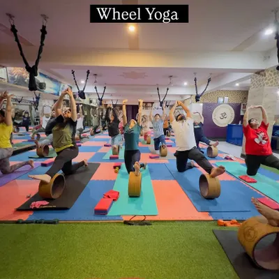 This is the energy you can expect in our classes. Here, we are using the yoga wheel to open our backs and build strength together. It’s a challenging but incredibly rewarding practice that we guide you through safely.