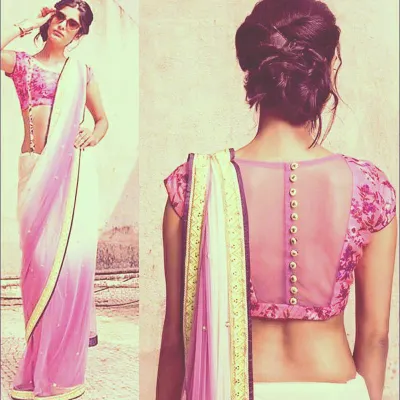 This blouse features a sheer back with a button-down detail, a popular choice for a modern and chic look. I can customize the fabric and fit to pair perfectly with any saree.