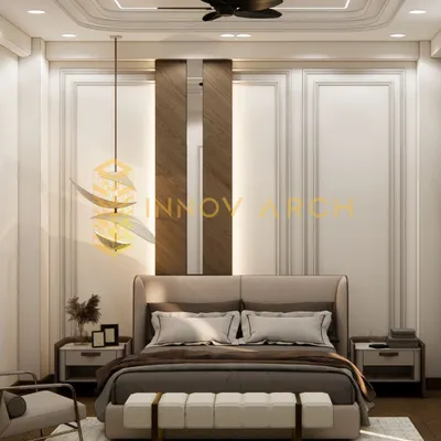 A serene and comfortable master bedroom design for a modern villa in Akansha Enclave. The room features classic wall moulding, a statement pendant light, and a balanced color palette, creating a perfect space for relaxation.