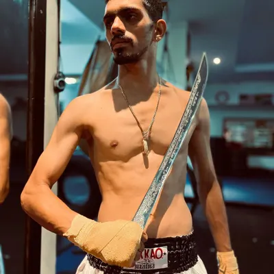 A student practicing with a Daab, a traditional Thai sword. This is part of our Muay Boran training, connecting our fighters to the history of the art.