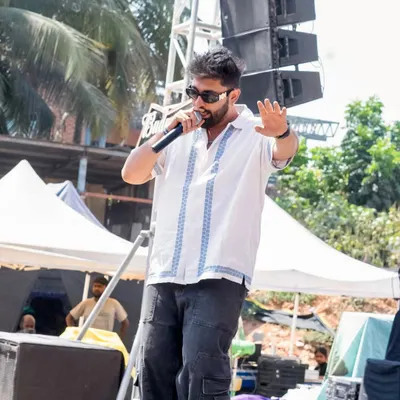 On the mic at a Holi festival, getting the crowd hyped up. There's nothing like the energy of an outdoor day party.