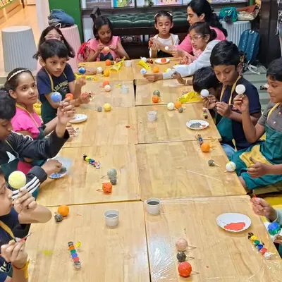 Students are busy painting the planets for their solar system models. This project combines science with art, making learning about astronomy fun and memorable.