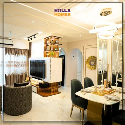 A look into our Parisian-themed living room, where every detail is curated for elegance. This space features a rotating TV unit, a luxurious dining area, and classic wall mouldings that create a sophisticated atmosphere.