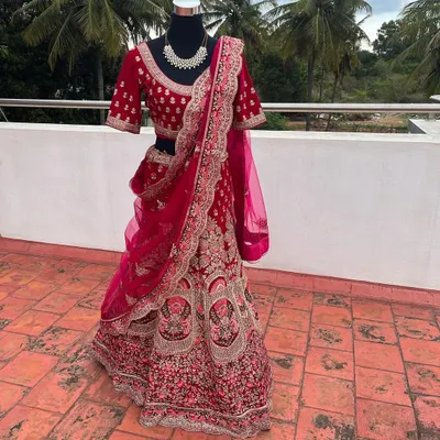 This is a glimpse of one of my premium bridal lehengas available for rent. The intricate velvet embroidery and rich magenta color make it a luxurious choice for a bride on her wedding day.