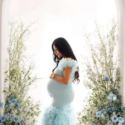 A truly magical shot of this mommy-to-be in a stunning blue ruffled gown, framed by an arch of blue and white flowers. This is one of my most requested setups for a reason.