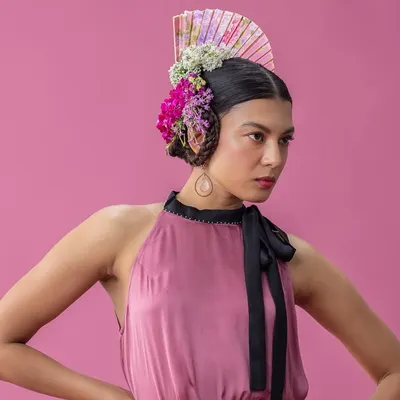 A key shot from the "Rainforest" series, where I combined a sculptural floral headpiece with a soft, halter-neck dress against a vibrant pink backdrop. This look is a perfect example of my avant-garde styling, blending natural elements with high fashion.