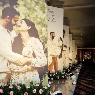 A truly personal wedding aisle. I designed this entrance walkway lined with life-size photos of the couple, telling their love story to guests as they arrived.