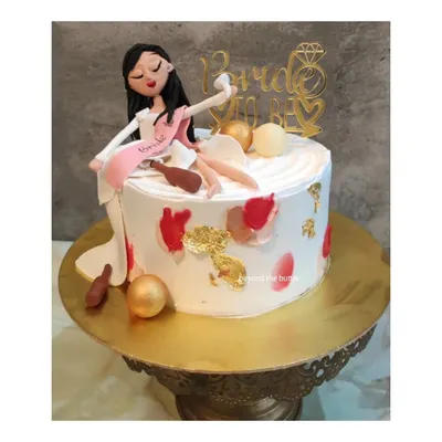 A fun and cheeky "Bride to be" cake for a bachelorette party. This design features a handmade figurine of the bride celebrating, complete with a sash and playful details.