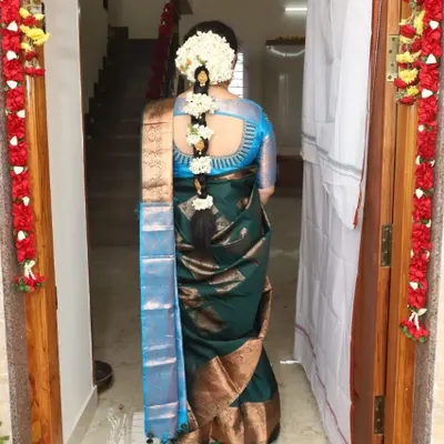 The quintessential South Indian bridal hairstyle. This long, thick braid is neatly woven and adorned with strings of fresh jasmine, creating a timeless and fragrant look for a wedding day.