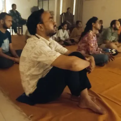 A participant sits in deep meditation during the Amavasya rituals. These nights are potent for dissolving limitations and connecting with a deeper dimension of life.